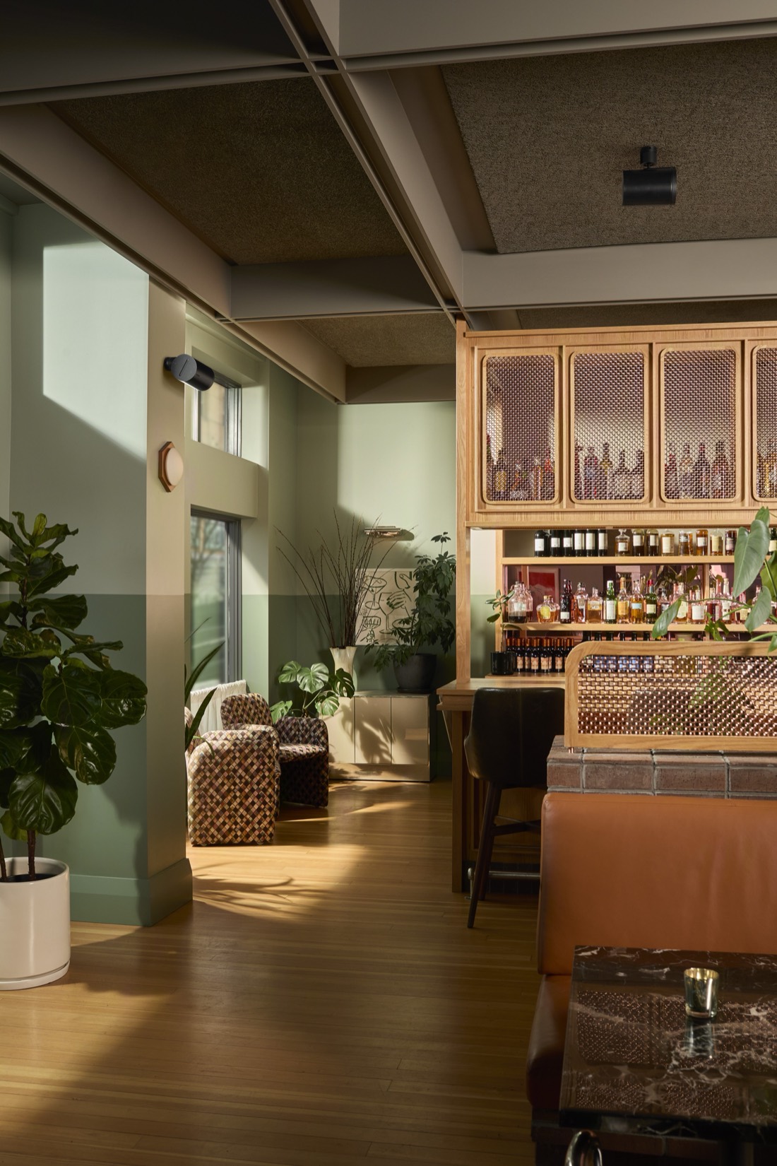 Cocktail bar with a ceiling-level wall-mounted commercial speaker