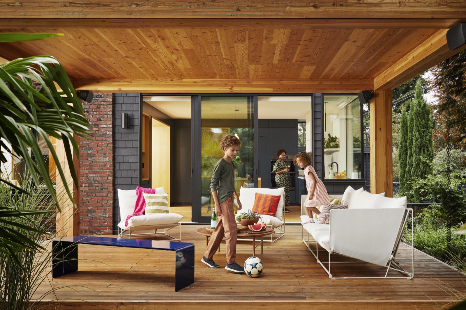Covered backyard porch with outdoor speakers mounted in the ceiling corners